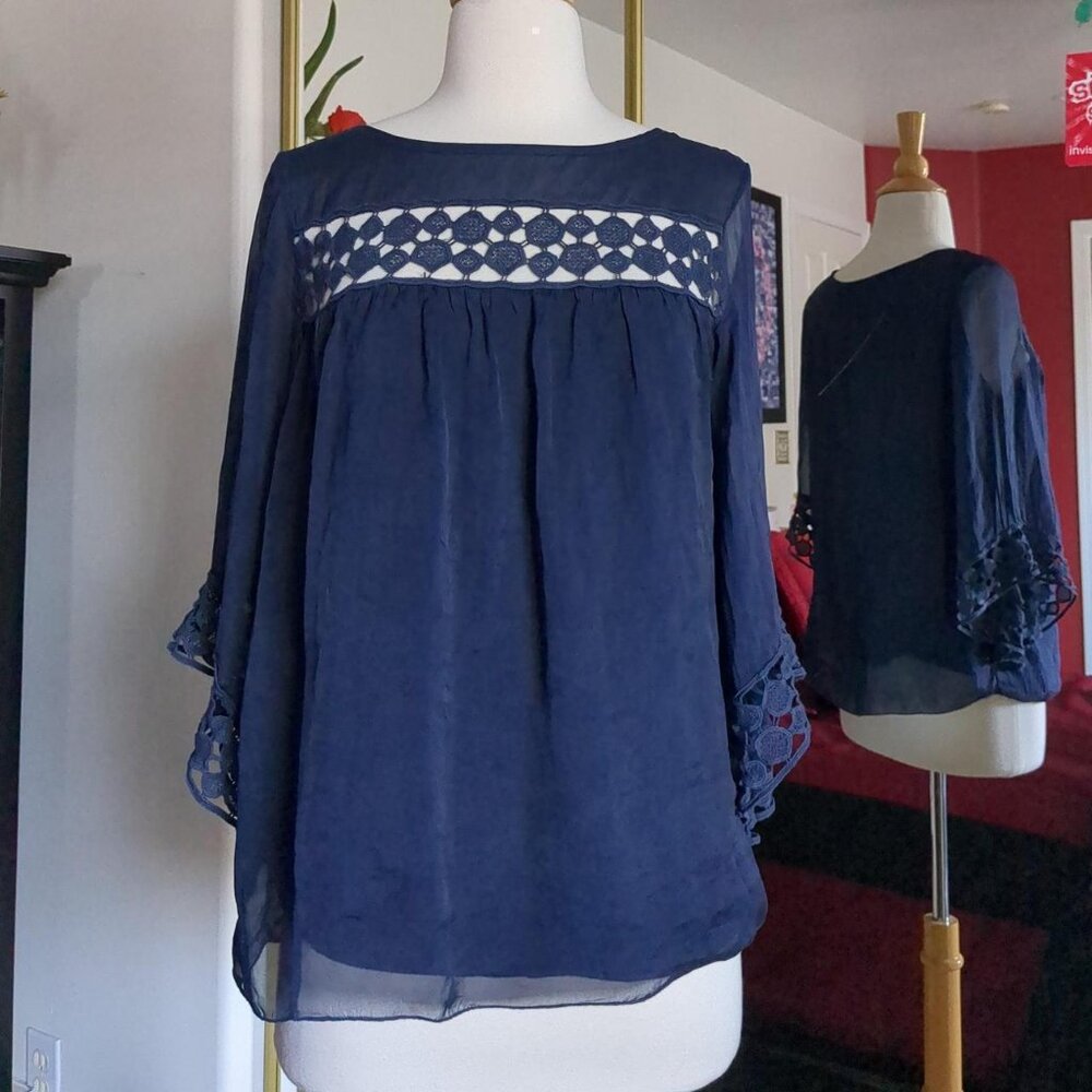 Navy blue soft blouse with lace eyelet cutouts at neck and sleeves